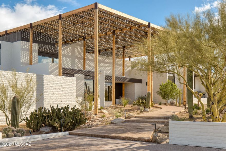Set across more than six pristine protected acres in the Catalina Foothills, with uninterrupted 360-degree mountain, desert, and city vistas, the Ramada House stands as a singular offering -- iconic, private, and now permanently protected. Originally conceived by renowned architect Judith Chafee in 1975, this is widely regarded as her masterpiece and one of the most significant examples of Desert Modernism in the American Southwest.

Listed on the National Register of Historic Places and internationally studied, the Ramada House is more than a residence -- it is a landmark of American architectural history, reintroduced in its strongest and most compelling form.  Qualified for reduced property taxes.  

Now fully restored and sensitively renovated by designer Casey W. Smith, the residence now stands in its most resolved architectural form -- its architectural integrity preserved, its systems and finishes thoughtfully elevated for modern living. Every refinement honors Chafee's original intent: disciplined geometry, filtered light, and architecture shaped by climate rather than trend.

A monumental timber ramada -- Chafee's defining gesture -- spans the residence, casting shifting patterns of light and shadow while creating a powerful thermal canopy above. Below, the home unfolds in layered planes that step naturally with the terrain. Terraces, courtyards, and transitional spaces dissolve the boundary between interior and desert, reinforcing the seamless integration of structure and landscape.

Concrete masonry construction, mortar-washed surfaces, and exposed structural timber speak to Chafee's rigorous modernism, while refined updates enhance livability without compromising architectural authenticity. The residence is also equipped with state-of-the-art twin gas-powered backup generators. Public and private spaces are thoughtfully layered, creating both intimate retreat and dramatic entertaining environments beneath the filtered desert light. 

The Ramada House has been featured in the MOMA traveling exhibit: "Judith Chafee: Framing the Desert" highlighting her contributions to regional, sustainable architecture, along with her international recognition. The Ramada House has been featured and studied on Smithsonian-affiliated architectural tours of the American Southwest.

Located within the most coveted enclave of the Catalina Foothills -- the storied "Old Foothills" -- this offering represents a rare convergence of architectural significance, land preservation, and enduring desert beauty.