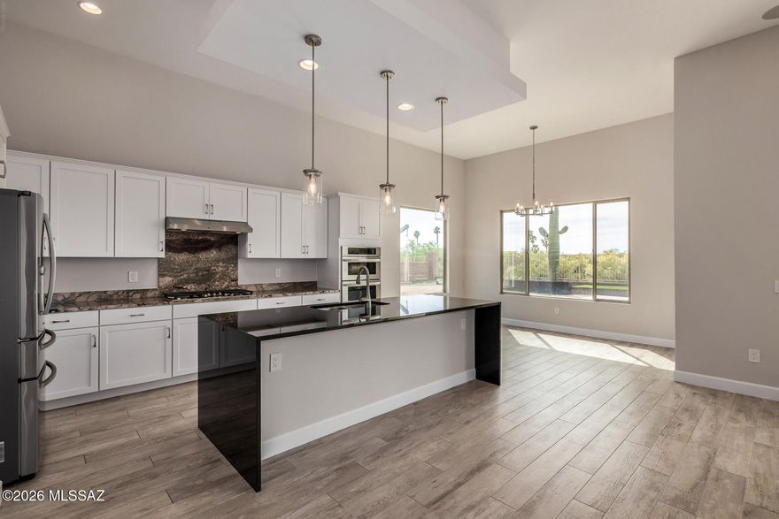 ** ACCEPTING BACKUP OFFERS ** Beautifully designed and built by Fairfield in 2023, this single-story home is nestled within a privately gated enclave in the heart of Rancho Vistoso! Talk about a fabulous split bedroom floor plan! Bedrooms two and three each have their own en-suite and walk-in closets. The primary retreat space has amazing views, spa like bathroom and huge closet. Each bedroom has brand new carpet. This floorpan also features a den/home office PLUS a teen room, which is a great flex space either as a kids playroom, or as a TV or hobby room. Enjoy the chef style kitchen with brand new black granite waterfall countertops on the island. Large living area with sliders to the covered patio and massive backyard space. Discover washer, dryer, cabinets, & a sink in the large laundry room. Desert-style backyard has mountain views, covered patio, artificial turf, & a sunken seating area w/cement benches. Great home, great location!
