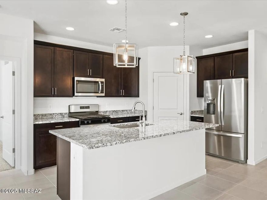 Brand new, energy-efficient home available NOW! The expansive great room of the Garnet is perfect for movie nights or watching the big game with friends. With four bedrooms, this home is great for entertaining guests, while the tucked away primary suite allows for privacy. Located less than 10 minutes from I-10, it offers convenient access to employment centers and downtown Tucson. This community features several amenities such as bike and walking trails and playgrounds. Move-in ready with a washer, dryer, fridge, and whole-home blinds; closing in 60 days or less - guaranteed. Each of our homes is built with innovative,
energy-efficient features designed to help you enjoy more savings, better health, real comfort and peace of mind.