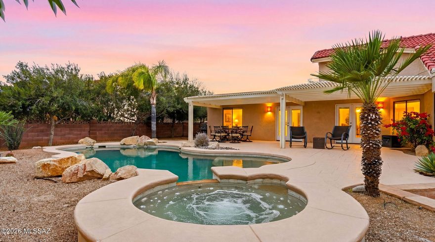 Amazing Desert Sanctuary on .7 acre  only 1 mile from Mt Lemon Biway in the shadow of Majestic Catalina Mtns. Versatile Split Floor Plan  has 2 wings so terrific Multi-Gen home with plenty of space for everyone. In sought after Tanque Verde School District, this property enchants with a completely private rear yard oasis +  extended natural area w/Fire Pit, TUFF Shed & Mesquite Trees. The  FULL LENGTH shady patio w/classic Flagstone Pavers helps keep the home cool.  Remodeled Kitchen delivers beauty w/Stunning Granite Counters/Travertine Backsplash/Cherry Wood Cabinets, Island AND Peninsula open to Great Room; an entertainer's delight:) All 3 Bathrooms Updated. 4 sets of Charming Graphite French Doors lead to extensive retreat patio. Elegant Travertine Flooring. New Water Heater. See more Entire home replumbed! West Wing built in 2005. NEW Irrigation System front/rear to include Low Voltage Wiring. Varying ceiling heights, arches and angles add intrigue to the layout that has ease of flow. Then, one step outside to the backyard retreat and you are a world away to relax & enjoy the awe inspiring Pebble Tec lagoon entry Pool & large Spa with waterfall & decorative boulders. Or, grab binoculars to enjoy countless varieties of birds that inhabitat.  Whether you enjoy sunrise, sunset, mountain VIEWS or big skyscapes that Tucson is famous for, all is yours to soak in without leaving home!!