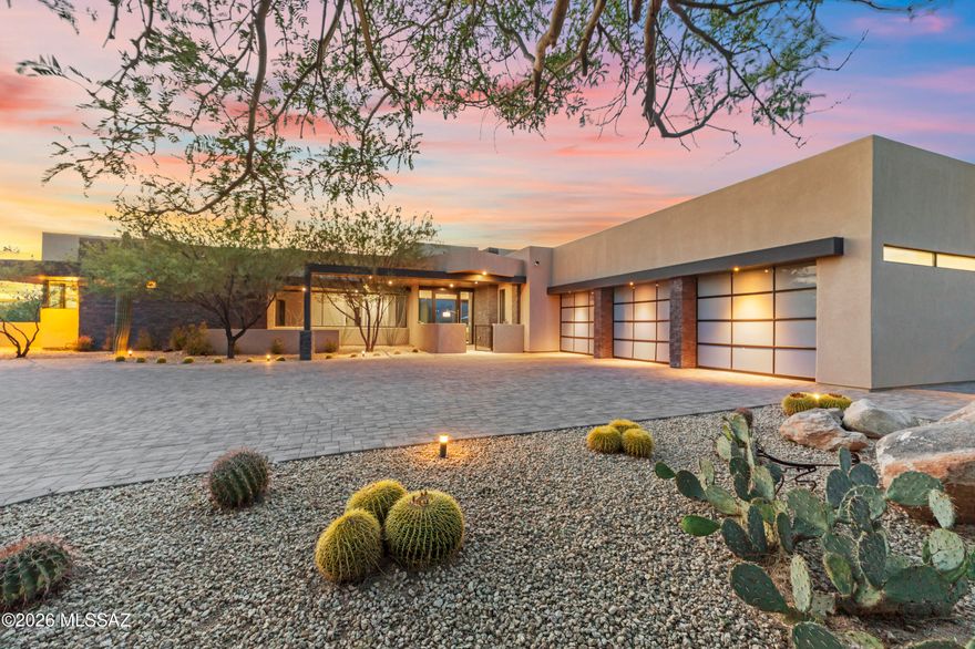 Set on a private .76-acre lot in Oro Valley's prestigious Stone Canyon community, this architectural masterpiece by renowned designer Marc Soloway blends clean contemporary lines with the raw beauty of the Sonoran Desert. Built in 2018 & spanning 3,682sf, the home is thoughtfully positioned to capture unobstructed Tortolita Mountain views protected by over 25 acres of HOA-owned open space directly behind the property. Experience striking modern design and effortless desert living with an open-concept floor plan that is both sophisticated & functional with 3BRs/4½BAs + versatile den/office/workout space w/patio access. Each bedroom is a private retreat with an ensuite bath & walk-in closet. Great room is designed for connection & comfort, anchored by high ceilings, gas fireplace with mantle, expansive collapsing sliding glass doors for seamless indoor-outdoor living w/remote-controlled window shades. Sleek chef's kitchen features quartz counters, stainless appliances, large island w/bar seating & walk-in pantry. Bar area has sink, wine cooler & ice maker making it ideal for entertaining or everyday living. Sophisticated powder room w/contemporary floating vanity, quartz counters, integrated vessel sink & elegant pendant lighting. Enjoy your own private backyard retreat, thoughtfully designed with low-maintenance desert landscaping, an extended paver patio, and wrought iron fencing with added snake-proofing. Take in breathtaking sunrises and sunsets as they paint the mountains in ever-changing color. The outdoor space is perfect for relaxing or entertaining, featuring a built-in BBQ, patio solar shade, and a soothing Vita 92x92 Envie spa ideal for unwinding under the desert sky. Residents enjoy membership at the exclusive Stone Canyon Club with access to the championship golf course, luxurious fitness facilities, tennis, pickleball and restaurant. This is a rare opportunity to own a modern desert sanctuary where architecture, privacy, and views come together in perfect harmony. Adjacent to the community are protected areas such as the Vistoso Trails Nature Preserve  and Honey Bee Canyon Park,& Catalina State Park which offer hiking trails and natural desert habitat.