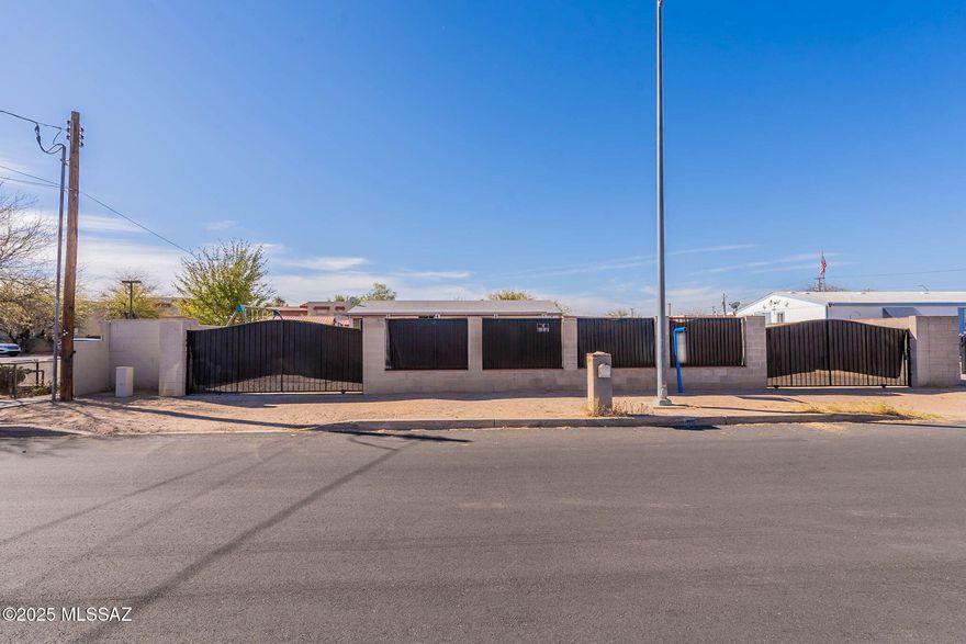 Gorgeous recently remodeled manufactured home on a large desirable lot. Beautiful kitchen with SS appliances, updated bathrooms and wood like vinyl flooring. Fenced front yard with rolling gates, large partially turfed backyard with above ground pool, 2 large storage sheds and a large covered patio. Plenty of parking space for cars and toys! Reduced energy bills with Solar! No HOA. Close to downtown, The University of Arizona, and much more! Could be a great rental/investment property!