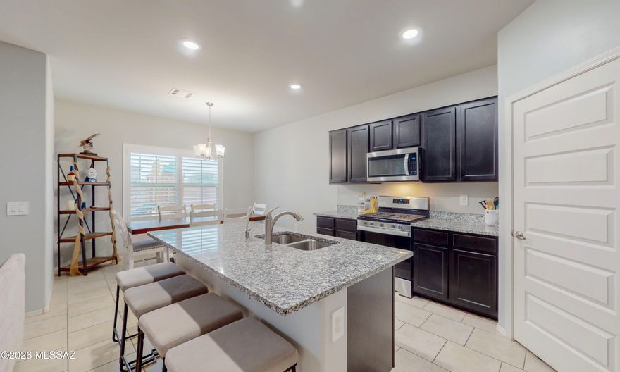Seller to pay off solar loan at closing saving buyer hundreds of dollars in electric bills! Situated on a spacious corner lot with no direct front neighbors, this 2022-built home offers privacy and modern design. The open-concept layout features granite countertops and contemporary finishes throughout. Spacious master bathroom with his and her closets. The backyard has been thoughtfully upgraded with pavers and low-maintenance artificial turf, and a wide gate for better access to backyard creating a clean and functional outdoor space.
