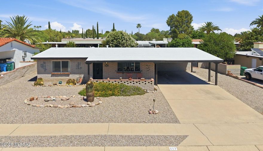 Well-maintained Southwestern slump block home built in 1972, lovingly owned by the same family since 1974 and enjoyed as a seasonal winter retreat. Located in the desirable Fairways 3 community with low HOA fees of just $60/year and wonderfully wide streets.
This 1,250 sq ft home offers 2 bedrooms, 2 baths, plus an AZ Room providing additional usable space. The property features a large 2-stall carport and is being sold furnished. 
The updated kitchen includes granite countertops, tile backsplash, newer cabinetry, a single-basin stainless steel sink with updated faucet, pantry closet, and a Pentair under-sink water filtration system with dedicated tap. A rolling butcher block island with drop-leaf extension adds flexibility and storage. Both bathrooms have been updated. The primary bath features a quartz vanity, a beautifully tiled walk-in shower with decorative accent band, pebble-stone floor, built-in niche, handheld showerhead, and grab bar. The guest bath includes a newer vanity with cultured marble and a tub/shower combo with a tiled surround.
Interior highlights include vaulted ceilings, no popcorn ceilings, and dual-pane windows (2007). Flooring consists of wood-look laminate in the main living areas, carpet in the bedrooms, luxury vinyl plank in the bathrooms, vinyl in the kitchen, and 17" glazed ceramic tile in the AZ Room. A chest freezer is included with the W/D in the laundry/storage room.
The primary bedroom features a walk-in closet. Exterior improvements include recently replaced posts for the covered front porch and carport, plus added stucco to the rear of the AZ Room for a cohesive exterior finish.
Take in mountain views from the private front porch. Enjoy outdoor living with a fully enclosed backyard featuring matching slump block walls, easy-care landscaping, a rose bush, chiminea, Weber kettle grill, and a decorative vase water fountain with electric pump. Alley access adds convenience. 
GVR membership delivers access to multiple recreation centers (pools and fitness facilities), lifelong learning opportunities, and a wide range of social and recreational activities.