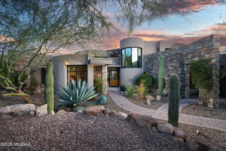 Timeless Contemporary Estate in Stone Canyon: Embrace unparalleled luxury and breathtaking desert landscapes in this exquisite 3-bedroom, 5-bathroom contemporary residence, beautifully situated on a 1.02-acre lot within the prestigious guard-gated Stone Canyon community. Designed by renowned Tucson architect Kevin Howard and built in 2008, this 4,453 sq ft home offers a lifestyle of sophistication and serenity amidst dramatic rock outcroppings and panoramic views of the Catalina Mountains and close up views of the saguaro studded Tortolita Mountains. This exceptional property offers a rare opportunity to own a meticulously designed and flawlessly executed contemporary estate in one of Oro Valley's most sought-after communities, providing a lifestyle of ultimate luxury and natural beauty.
