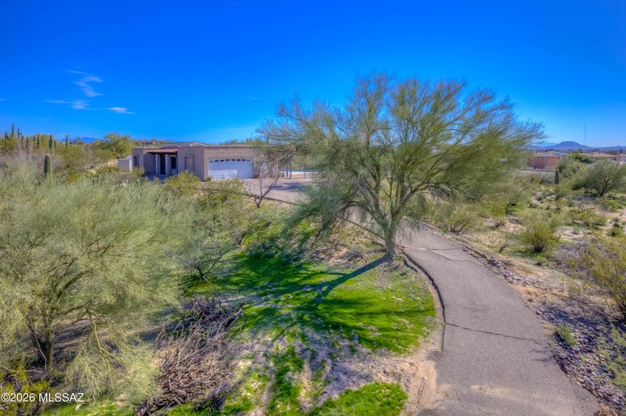 Hilltop home in desirable NW Tucson situated on a spacious 1.42-acre lot offering privacy, elevation, and Arizona outdoor living.  Private pool with west Tucson mountain, city and Sunset views. Expansive grounds with room to relax and entertain.  The home features a fully paid-off solar panel system providing energy efficiency and long-term savings. Features recent repairs and updates to interior and exterior such as polished floors, pool patio resurfaced and re-landscaped. Previous updated windows. Is a 3 bedroom 2 full bath home with fireplace. Attached 2 car garage. 2 sheds. Conveniently located near shopping, restaurants, and hospitals, this property offers peaceful living with easy access to everyday amenities.