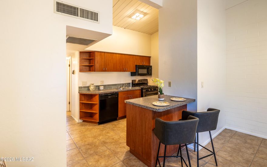 STOP paying utility bills! This stunning Royal Alvernon condo offers a ''lock-and-leave'' lifestyle where the HOA handles the heavy lifting--including your heating, cooling, sewer, water, and gas. 

A second-floor, turnkey residence that perfectly merges imid-century design with modern upgrades in the heart of Tucson. Step through your private covered entrance into an airy, open-concept living area defined by soaring, vaulted wood-beam ceilings and an abundance of natural light.

The modern kitchen has been thoughtfully refreshed with stylish new appliances. An extra bonus is the in-unit stackable washer and dryer. 

Gated community with pool, clubhouse and covered parking. HOA INCLUDES UTILITIES: Gas, HVAC, water, sewer, trash, pest control, and roof/exterior maintenance are all included, offering an unparalleled "maintenance-free" ownership experience. The Tucson Botanical Gardens, TMC, the University of Arizona, and I-10 are minutes away.