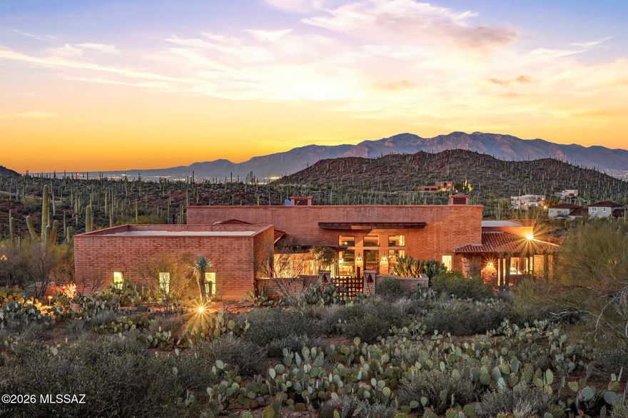 A truly one-of-a-kind desert oasis retreat nestled high in the Tucson Mountains on 10+ acres, just minutes from Saguaro National Park and Sweetwater Preserve. This custom-built estate offers approximately 3,700 sq ft of luxurious living space and showcases rare, artistic architecture, upgraded to absolute perfection. The main residence is a designer home that feels like a private resort, featuring serene waterfalls, a saltwater zero-edge PebbleTec pool designed to resemble a natural swimming hole, and a primary suite with its own private porch accessed by sliding doors. Thoughtful details include hand-milled cabinetry and doors, colored concrete floors and countertops, plaster walls, and three fireplaces, all blending seamlessly with the surrounding desert landscape. The main home also features a unique outdoor shower, enhancing the spa-like, resort experience. A secondary home provides a full bedroom, full bathroom, complete kitchen, and full-size laundry--ideal for extended family, guests, or investment opportunity--and includes its own outdoor shower for added comfort and convenience. Additionally, a bonus casita, converted from the garage, offers a full kitchen, laundry, and a private bedroom with a bath, enclosed by a 10-foot stucco wall for ultimate privacy. The estate welcomes you through an inviting courtyard entry with fountain ponds, while wraparound patios featuring Spanish roof tiles and red brick pavers create multiple spaces for relaxation and entertaining. Bathrooms are finished with travertine, limestone, and natural stone slabs, reinforcing the home's organic, luxurious feel. This is more than a property - it's a rare desert haven offering privacy, artistry, and resort-style living in one of Tucson's most breathtaking settings.