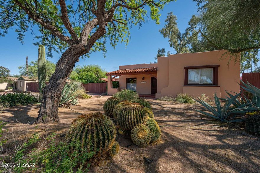 LIMITED TIME OFFER!! $15,000 CONCESSION OR REDUCTION TO BUY DOWN THE INTEREST RATE AND COVER YOUR COSTS. CALL FOR DETAILS.  A rare 1936 double-brick gem in Poet's Square, rich with Tucson character and set on a coveted double lot with no HOA. Main home features original scored concrete and hardwood floors throughout. Two fireplaces, stained glass windows, and arched details create timeless warmth. Spacious bedrooms with walk-ins plus a private-entry 3rd bd/bonus room. Updated HVAC, washer/dryer and water heater provide comfort & peace of mind. Lush hummingbird/butterfly garden, mature trees, fountain, hot tub, outdoor shower, workshop/Tuff Shed, 8' privacy wall and room for RV parking. Ample room for expansion.