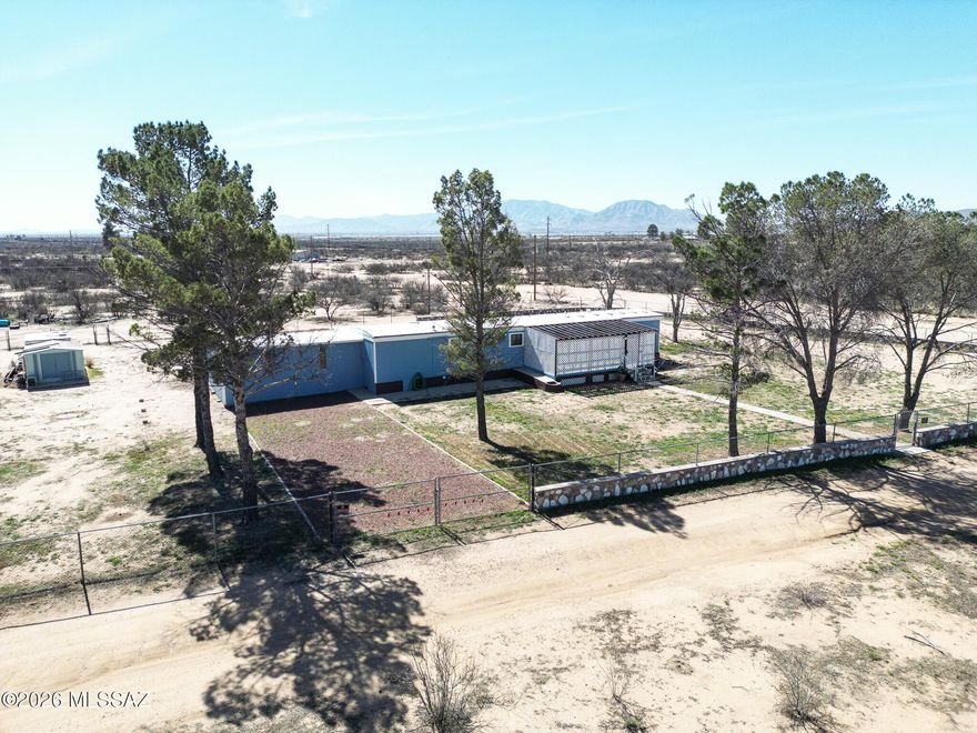 This charming property offers the perfect blend of privacy and beauty.. The home sits on .70 acres that are fully fenced and gated,, highlighted by a concrete wall with vibrant colored stones sourced from a local mine. This 980 sq ft home features 2 bedroom and bathrooms, an attached shop (338 sq ft) and two storage sheds. Enjoy the front and back porches, ideal for morning coffee and evening sunsets. Every aspect of this home has been thoughtfully maintained and improved, allowing for the next owner to move in with confidence. Three additional lots, equaling 1.41 acres, are included to the South of the home. All furniture and contents are included!!!  If you're looking for quiet country living with character, craftsmanship and panoramic views, this property is ready to welcome you.