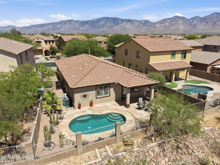 Welcome to this impeccably maintained, single-story contemporary gem nestled within a highly desirable community of Oro Valley. This 3BD/2BA with an office (1,846 sqft) ''Ford'' plan perfectly blends modern open-concept layout with comfortable, everyday luxury. Featuring a saltwater PebbleTec, pool that's heated, you just need to walk out back to enjoy your own private oasis! From the moment you step inside, you are greeted by an expansive open Great Room bathed in natural light, making it feel bright, open, and instantly inviting. The heart of the home is a beautiful chef's kitchen featuring premium appliances, gorgeous granite countertops, and a massive pantry that ensures everything has its place. A dedicated dining area sits adjacent to the main living space, offering the perfect spot for holiday hosting or intimate family dinners. The thoughtful floor plan provides seamless flow and ultimate privacy. You will enjoy new tile and laminate flooring throughout the home, with no carpet in sight. The primary suite serves as your own personal sanctuary, boasting a spacious layout, an expansive walk-in closet, and a deluxe private bath designed for total relaxation. Two additional bedrooms provide great versatility for a growing family, guest rooms, or a quiet work-from-home office space. Outdoor living is a true delight out on the covered rear patio, which opens to a low-maintenance yard backing up to a quiet green space. This home offers incredible convenience just moments away from Oro Valley's extensive trail systems, scenic parks, local shopping centers, and top-rated schools. It is truly move-in ready and waiting for its next chapter!