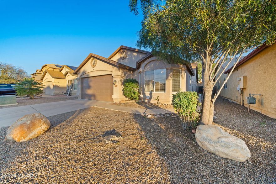 Move in ready home! Concrete stained flooring in living areas with newer upgraded carpet in the bedrooms. Spacious living room with fireplace centered in decorative stone.  Fresh 2 tone paint  throughout. Upgraded cabinets and countertops in kitchen and bathrooms. Remodeled primary shower with tile surround.  Extended covered back patio. Roof replaced in 2022 and newer water heater. Located in the Vail School district.