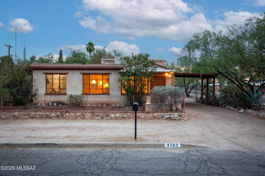 Located in the San Gabriel neighborhood, this charming 1949 bungalow blends original character with a well-balanced floor plan and thoughtful addition. Wood-beamed ceilings and polished concrete floors anchor the main living spaces, with a defined living room that opens into a central dining area, creating a natural flow for everyday living.

The kitchen sits just off the dining room, with direct access to a dedicated laundry/utility room and rear patio, allowing for easy indoor-outdoor connection. The original bedroom and hall bath are set toward the front of the home, while the primary suite addition is privately positioned at the rear. Generous in scale, the primary offers high ceilings, a walk-in closet, and an en-suite bath.

An enclosed entry adds a sense of arrival, while the la corner lot--shaded by mature mesquite trees--provides a spacious yard with room to expand or further enhance outdoor living. Just blocks from Reid Park and close to neighborhood parks, shopping, and schools, the location combines convenience with a strong neighborhood feel.