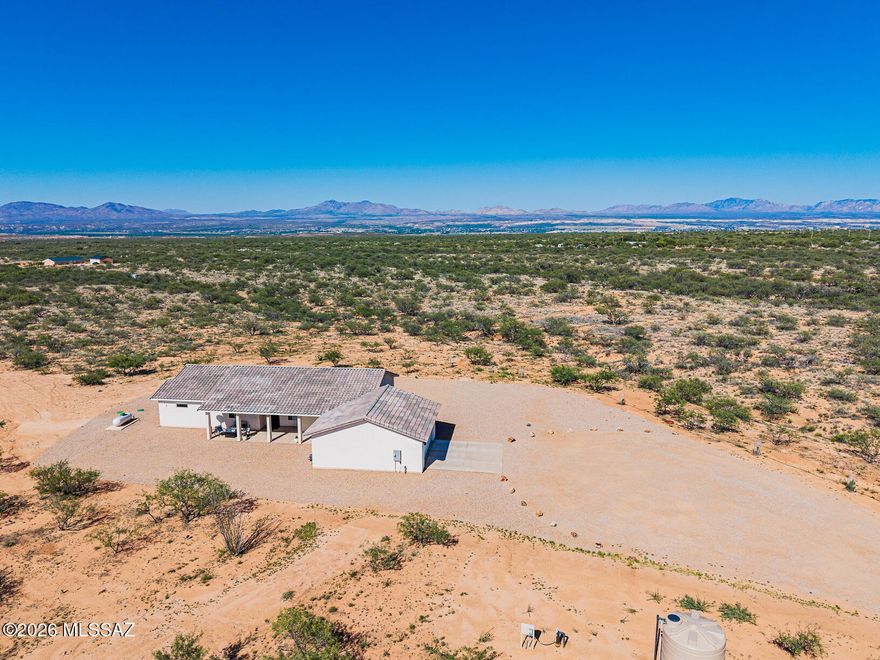**Stunning Energy-Efficient Home on Expansive 10-Acre Lot with Breathtaking Mountain Views**

Welcome to your dream oasis! Nestled in a tranquil private square, this immaculate home offers an unparalleled blend of modern luxury and country charm. With an expansive 10-acre lot zoned RU4, the possibilities are endless - consider building a workshop, a quaint casita, or horse stables to embrace your equestrian lifestyle.

This exceptional property combines the best of modern living with the tranquility of country life. Don't miss your chance to own this energy-efficient sanctuary with limitless potential. Schedule your private showing today and envision the lifestyle that awaits you! **Key Features:**

**9 foot ceilings 
**Spacious Living**: The heart of this home is its open-concept living space, featuring a stunning a 5-panel sliding/folding door system that seamlessly integrates indoor and outdoor living. Natural light floods the space, enhanced by motorized custom shades and tasteful custom blinds throughout.

 **Chef's Delight**: Cook and entertain in style with a gourmet kitchen equipped with double ovens (including a gas range and electric built-in oven), a counter-depth refrigerator, a built-in microwave, and a dishwasher. The Mont Blanc Quartzite countertops and soft-close custom cabinets with pull-outs ensure both functionality and elegance.

**Luxurious Bathrooms**: Relax in the spacious master bath, featuring a large shower with steam shower doors and bench, as well as exquisite large-format tiles. The guest bath also boasts stylish finishes, accentuating the home's modern aesthetic.

**Energy Efficiency**: This energy-efficient home is fortified with 6" spray foam insulation throughout, ensuring comfort year-round while keeping utility costs low. The dual mini-split ducted HVAC system and Ecobee Smart Thermostats provide optimal climate control tailored to your preferences.

 **Outdoor Paradise**: Enjoy the serenity of your private 10-acre lot, adorned with a low-maintenance gravel yard and equipped with a drip irrigation system. Three covered patios provide perfect spots for outdoor dining, relaxation, and soaking in the stunning 360-degree mountain views.

**Modern Conveniences**: The property is equipped with a brand-new private well (registered in 2024) featuring a 2500-gallon storage tank, a pump saver, and a booster pump system from Western Hydro Engineering. The home is wired for modern living with security cameras, a Ring Doorbell, and an EV/Welding outlet in the oversized garage (24'x27'), which also boasts an epoxy-coated floor for added durability.

 **Additional Amenities**: This property is as versatile as it is luxurious, with pre-wiring for a hot tub/spa and ample room for future expansions. Enjoy the added security of a custom steel door, and benefit from the stainless-steel appliances and recessed lighting throughout.

- **Ideal Location**: With easy access to I-10, your new home offers a convenient commute to Vail, Davis-Monthan AFB, Tucson, Fort Huachuca, and Sierra Vista. Additionally, you are less than 100 feet from a paved county-maintained road, ensuring smooth access year-round.