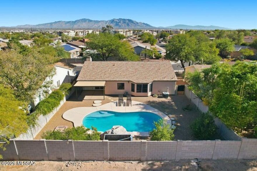 SUMMER IS HERE make the most of it in Marana's lowest-priced home with a pool and stunning mountain views. This 3-bedroom, 2-bath home offers comfort and potential with a cozy gas fireplace, beautiful plank wood flooring throughout (no carpet), and a spacious 2-car garage. Step outside to a private backyard with no neighbors behind you and breathtaking mountain views right outside your door. Major updates are already taken care of with a NEW roof and HVAC system, plus no poly pipes for added peace of mind. Enjoy a neighborhood park with a playground and sports courts just one block away. While the home offers an opportunity for cosmetic updates, that means you get the chance to create your own style and design choices rather than paying for someone else's taste.