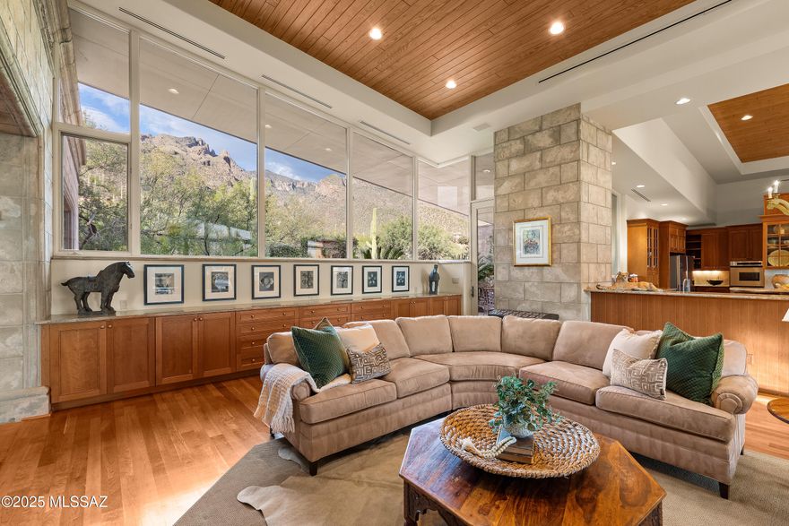 Designed by renowned architect Michael Franks, this extraordinary single owner custom built residence is one of a kind. From the dramatic walls of glass bringing the lush exterior spaces indoors, to the richly layered materials of cherry wood and custom concrete which perfectly juxtapose the modern lines of this home against its unparalleled natural environment. With a sprawling split floor plan that offers formal and flexible spaces, every room exudes a refined blend of artistry and craftsmanship which make it warm and intimate. Set within an exclusive guard gated community with paver finished roads, this private home captures timeless elegance and exceptional design integrity. Elegant stone and cast concrete at the entry continue seamlessly to interior spaces complementing three dramatic fireplaces and two outdoor fireplaces that anchor the home's ambiance. Expansive glass windows frame sweeping city and mountain vistas, while tongue-and-groove vaulted ceilings, solid wood flooring, and custom cast concrete details create a sense of timeless architectural distinction. Eight-foot solid wood interior doors, bespoke built-ins, and custom bookcases further elevate the home's interior sophistication.

The chef's kitchen is a masterpiece of form and function, featuring cherry cabinetry, three sinks, dual ovens, and dual refrigeratorsideal for both everyday living and entertaining. Numerous other accouterments such as a warming drawer, beverage refrigerators, and a butler's pantry position this residence for the highest level of entertaining.

Private spaces in this home offer character and quality accommodations for both owner and guests. A split floor plan provides privacy from two well appointed bedrooms while the primary suite is positioned near a fourth bedroom perfect for use as an additional bedroom, media room, or home fitness center. Unquestionably positioned at the most perfect location on this grand parcel though is the primary suite. Through a private den you enter this breathtaking space to a view of our stunning Tucson skyline and the mountains beyond. Two walk-in closets accompany the gracious bathroom with refined finishes and copious storage. A walk-in steam shower, garden tub, private water closet, and dual vanities complete this retreat.
The four car garage features extensive built-in cabinetry and additional storage space for convenience. The new standing-seam metal roof completes this architectural nonpareil  an exceptional expression of design, quality, and Tucson's natural beauty.