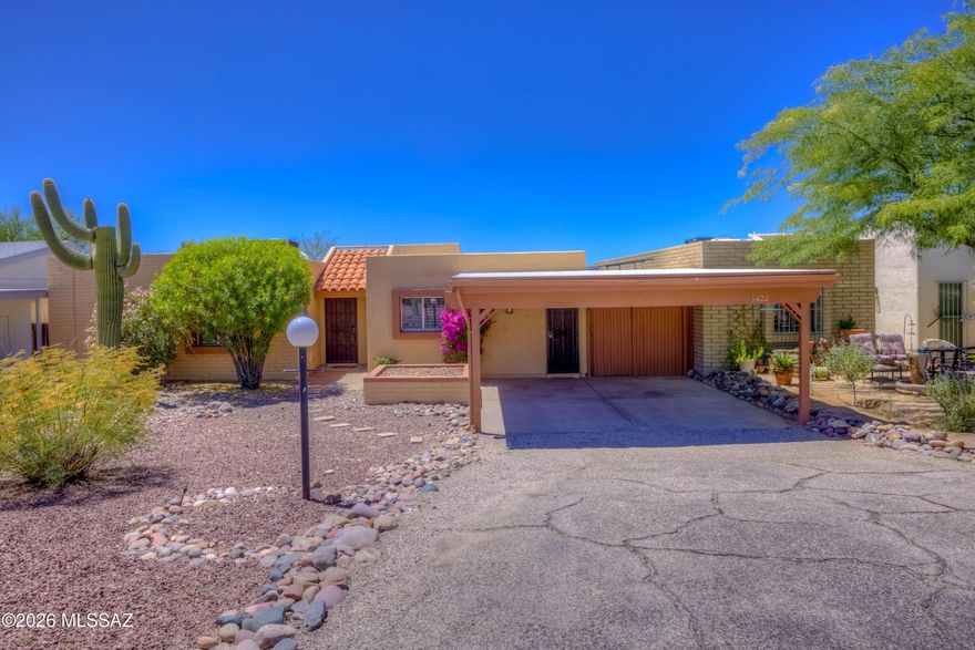 Located in one of the most scenic areas of town, with the Rincon Mountains to the east and the Catalina Mountains to the north, this charming townhouse in peaceful Village Greens offers the perfect balance of tranquility and convenience. Huge benefits of solar electric. Enjoy the serene covered patio overlooking a spacious backyard with natural desert behind--no rear neighbors for added privacy. The inviting curb appeal features a raised flower bed, desert landscaping, and decorative rock. Residents also enjoy access to community amenities including the pool, basketball court and pickleball / tennis courts, making this a wonderful place to call home.