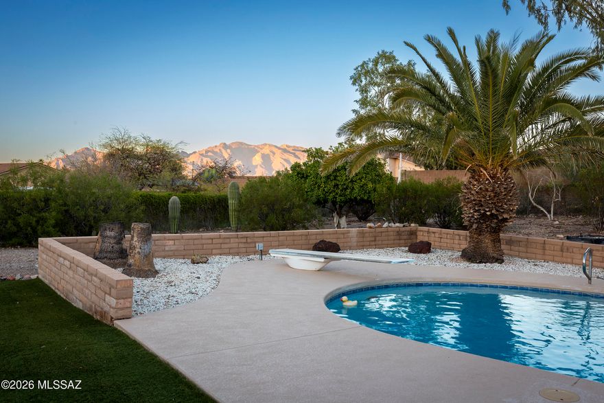 Discover desert living at its finest in this beautifully maintained Tucson residence, perfectly situated on a nearly three-quarter-acre lot in the desirable Frontier West Estates community. This spacious property offers a rare combination of privacy, functionality, and mountain views. The home features a two-car attached garage, a detached RV garage, and an additional two-car garage with workshop space. The backyard is an entertainer's dream with a private pool, mature desert landscaping, and peaceful spaces to enjoy Arizona sunsets. Energy-efficient  solar panels keep utility costs low year-round. A detailed list of upgrades and extras is available in the attached documents tab. A truly unique property with endless potential-schedule your private showing today!
