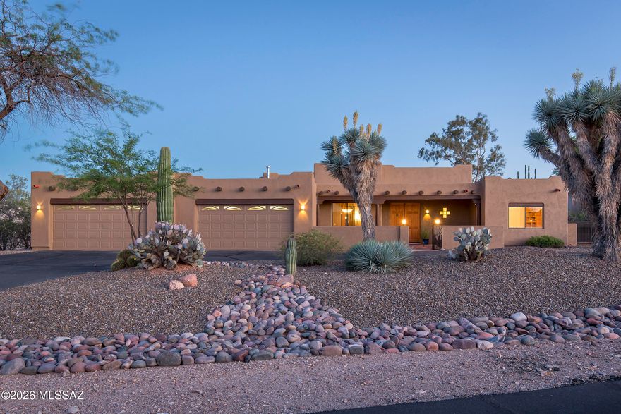 Located within the exclusive Los Arroyos Del Oeste gated community, this stunning custom Santa Fe home rests on a generous 1.14-acre lot, thoughtfully designed to embrace the beauty of indoor-outdoor desert living.

At the heart of the home, a dramatic great room impresses with soaring 14-foot ceilings and a classic kiva fireplace, flowing seamlessly into an open-concept kitchen appointed with granite countertops and a sunny breakfast nook. A separate formal dining room and an elegant built-in bar make entertaining effortless. The split four-bedroom floor plan offers both privacy and versatility for today's lifestyle.

The luxurious primary suite is a true retreat, featuring a soaking tub, separate shower, dual vanities, and a spacious walk-in closet -- all opening through sliding glas door to the outdoor oasis beyond. A fourth bedroom with its own separate entrance provides the perfect setting for guest quarters, a home studio, or a private office.
Step outside to a resort-caliber backyard built for unforgettable gatherings. A shimmering Pebble Tec pool and spa with a cascading waterfall set the stage, while a beehive fireplace, outdoor kitchen with built-in natural gas BBQ, and a sleek bar with polished concrete counters elevate every occasion. An expansive wood-beamed covered patio, multiple lounging areas, mature trees, stately saguaros, and a fully block-walled yard frame sweeping mountain views -- creating an authentic desert sanctuary unlike any other.

Completing this exceptional property is an oversized four-car garage offering abundant space for vehicles, storage, and all of life's extras.