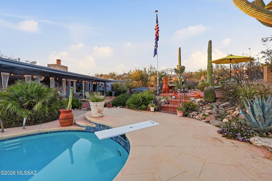 Mountain views set the stage for this five bedroom, two bath home tucked on a private lot with an incredible backyard oasis. enjoy sunny Arizona days by the sparkling pool and unwind on cool desert evenings beside the the charming beehive-shaped fireplace. inside, soaring high ceilings create a bright , open feel, while the spacious layout offers comfort and flexibility for any lifestyle. the bonus fifth bedroom with its own outside is perfect for guests, a home office or multigenerational living.