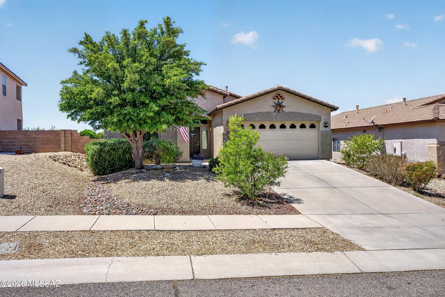 Welcome to this beautifully maintained 3bd/2ba in the highly acclaimed Vail School District! Sited on a premium lot, this home offers exceptional privacy-backing to common area with no immediate rear neighbors. Enjoy energy savings with OWNED SOLAR, a 2021 HVAC (17 SEER2) & extra attic insulation! Inside, you'll find a gourmet kitchen w/granite counters, large island w/breakfast bar, SS appliances & spacious great room w/gas fireplace. Owner's suite features large walk-in closet, soaking tub & separate shower. Additional highlights include oversized diagonal tile, room-darkening window coverings & an impressive finished garage w/epoxy, 4-ft extension, cabinets, workbench & storage. Private backyard oasis w/full length covered patio, water feature & stunning landscaping. SEE UPGRADE SHEET!!
