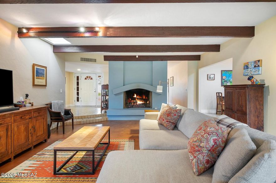 Classic burnt adobe ranch home in the heart of central Tucson. Featuring 5 spacious bedrooms and 3 full bathrooms, this unique residence blends classic Southwestern charm with modern comforts. Enjoy stained concrete floors and decorative tile throughout, creating a cool, cohesive interior. Step outside to your private oasis: sparkling pool, hot tub, large covered paver patio, & built-in BBQ—perfect for entertaining. Split bedroom plan great for multi-generational living or work from home. Eco-friendly rainwater harvesting adds smart sustainability. 2-car carport offers convenience, while the prime location places you minutes from the University of Arizona, Reid Park, shopping, dining, and all essential amenities. A rare opportunity to own a true Tucson gem!