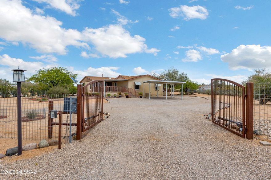 Welcome HOME to this lovely desert spacious retreat on a flat, usable acre near the Saguaro National Monument. This fabulous 4 bedroom 2 bath with a split floorplan PLUS a Den/Office/TV Room! Super functional floorplan with lots of living space, privacy & the perfect entertaining setting. The kitchen is open with a large island, lots of cabinets & a huge walk-in pantry plus a lovely breakfast nook to enjoy your morning coffee! The four bedrooms are super spacious & functional. The primary suite is large with an incredible walk-in closet done to the nines! Plus.... there are two large covered patios to enjoy the yard & the sunsets & sunrises. Tuff Shed with power for endless tinkering & creating. This home has been loved upon since day one & it truly shows! Don't miss this slice of heaven!