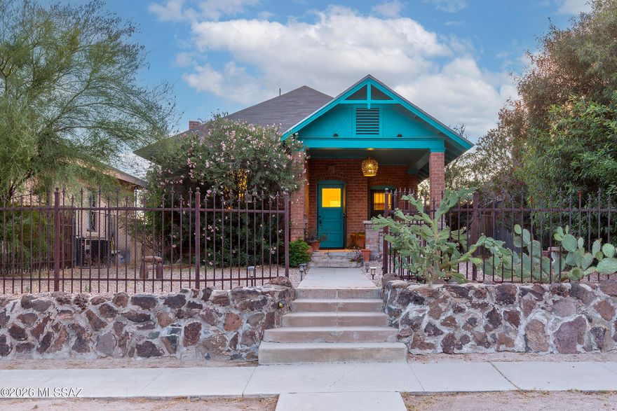 c.1907 bungalow located in the historic West University Neighborhood. Built in the transitional Craftsman style, this 2-bedroom, 1.25-bath home features exposed brick construction along with a foundation and front retaining wall built from quarried volcanic from the base of Sentinel Peak. Two front doors off the front porch originally allowed the owner to either operate a professional practice or rent a room to travelers arriving by rail -- (the early 1900s version of Airbnb ) -- reflecting the property's deep Tucson roots. The more liberal commercial zoning and rear access from Echols Avenue allow for greater flexibility and potential future uses. Ideally located near Downtown Tucson, historic 4th Avenue, the University of Arizona, and a wide variety of restaurants and entertainment venue