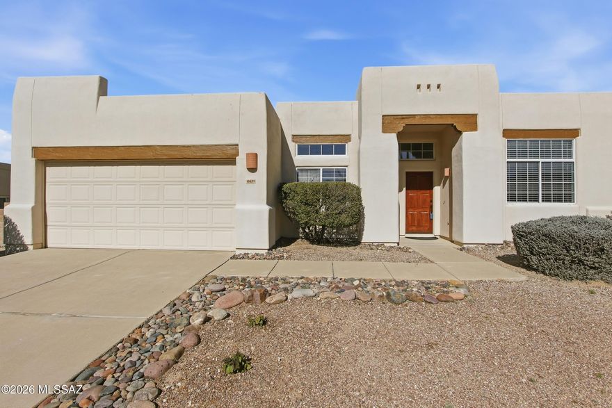 This beautifully renovated, open-concept home is designed for both elegant entertaining and everyday comfort. The front of the home features a spacious formal living room and refined dining room, while the rear opens to an expansive great room with a cozy fireplace, seamlessly connected to the kitchen—ideal for hosting gatherings large or small. The low-maintenance front yard frames an inviting entryway, setting the tone from the moment you arrive. Step into the backyard retreat, a serene oasis complete with artificial turf, decorative rock accents, a flagstone pathway, and a generous covered patio—perfect for relaxing or entertaining year-round.