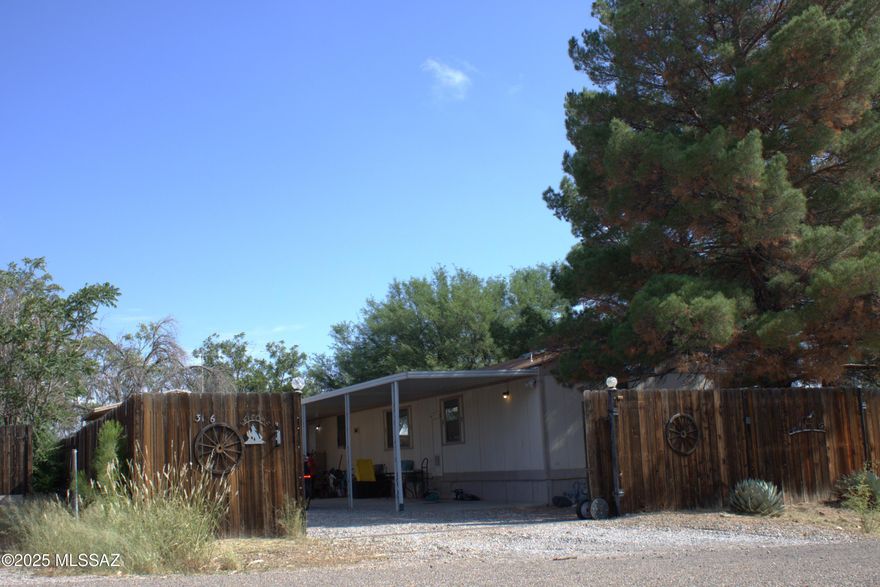 Spacious 2 Bedroom 2 full bath with split floor plan. Large living area with dining room/ Kitchen. Decks on both sides of the home to take in the natural beauty. 6 large pine trees watered by rain/gray water from the underground tank. Large backyard with beautiful patio will be perfect for summer BBQ's. Workshop with electric, Covered parking plus space for RV. Completely fenced in with wood privacy fencing and rolling gate all on a corner lot. New water heater and septic is scheduled to be replaced. Hurry to see this home today!