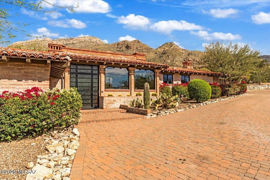 A rare opportunity to own a stunning piece of Tucson architectural history. Designed & built in 1963 by renowned Tucson architect Lewis Hall, this authentic burnt adobe residence embodies Hall's commitment to desert-sensitive design and his connection to the legacy of Josias Joesler. Hall masterfully blended Old World craftsmanship with Sonoran Desert materials -- thick masonry walls, hand-finished details, deep overhangs, and a seamless relationship between structure and landscape. Set on a private 1-acre lot within landmark Skyline Country Club, this 3,978 sq ft residence captures breathtaking Catalina Mountain views through expansive picture windows while embracing mature desert vegetation and natural terrain. Thoughtfully designed for both intimate living and gracious entertaining, the home features 4 bedrooms and 3.5 bathrooms, a bonus/opt 4th bedroom, two striking fireplaces, upscale kitchen design, gorgeous wood floors throughout, hand-hewn wood beams and classic burnt adobe construction. Multiple patios create effortless indoor/outdoor living, spiral staircase leads to a roof deck -- the perfect vantage point to take in dazzling sunsets. An expansive circular paver drive and 2-car garage complete the estate setting. The combination of architectural provenance, authentic materials, generous lot size, and iconic foothills location makes this a truly exceptional offering -- ideal for buyers who value timeless Southwest design, historic influence, very high-quality finishes and the enduring beauty of desert-adaptive architecture.