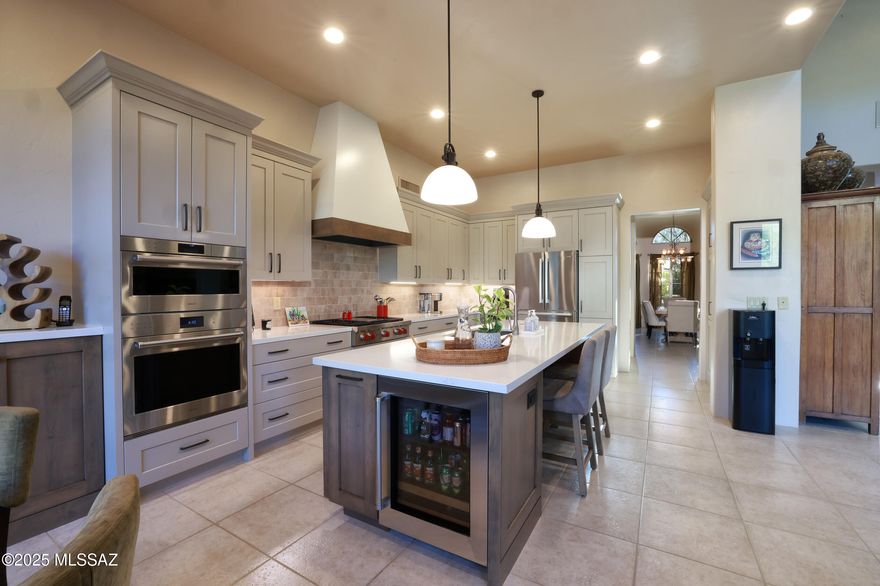 This beautifully updated home features breathtaking mountain views on 3.2 Acres with a 4 car garage & Rock waterfall and elevated heated spa that flows beautifully into the heated pool. A gated front courtyard with a soothing fountain welcomes you and sets the tone for what you're about to experience. Step through the custom mesquite entry door into a light-filled living space with walls of windows that frame the surrounding scenery. The gourmet kitchen, completely remodeled in 2023, showcases shaker-style cabinetry with lots of drawers. All Stainless steel appliances with Bosch refrigerator and top of the line WOLF gas cooktop with griddle, WOLF convection oven, WOLF steam oven.  - a dream for any home chef.  With 4 bedrooms plus an office, plus a den/TV room and 4 full baths... there's plenty of space for everyone.The luxurious primary suite offers a private sitting area, a two-sided fireplace, spa-like bath, and a large walk-in closet.
Step outside to your resort-style backyard featuring a sparkling pool with rock waterfall, heated spa, outdoor fireplace, and artificial turf for easy care. The built-in outdoor kitchen with BBQ and seating is perfect for entertaining under the stars.
Additional highlights include a tankless water heater (2021), two newer HVAC systems (2019), and a high-efficiency water softener. All this just half a mile from the trailhead, where you can enjoy hiking and the beauty of nature right outside your door.
