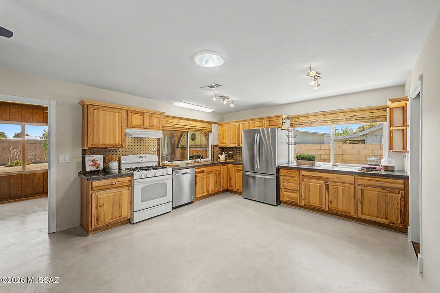 Discover this charming 3-bedroom, 2-bath home in sought-after Wildwood Park! Enjoy worry-free living with major upgrades: HVAC (2018), water heater (2023), new appliances, fresh paint, new carpet, stylish concrete flooring, and a durable metal roof. Located in the highly rated Flowing Wells school district, this move-in ready home is close to parks, playgrounds, restaurants, shopping, hospitals, and the Loop Bike Path. Features include NO HOA, laundry room, pantry, 2-car garage with storage, vinyl siding, a 2-story shed, and RV parking--perfect for gatherings and holidays! Review the upgrades sheet for more details!