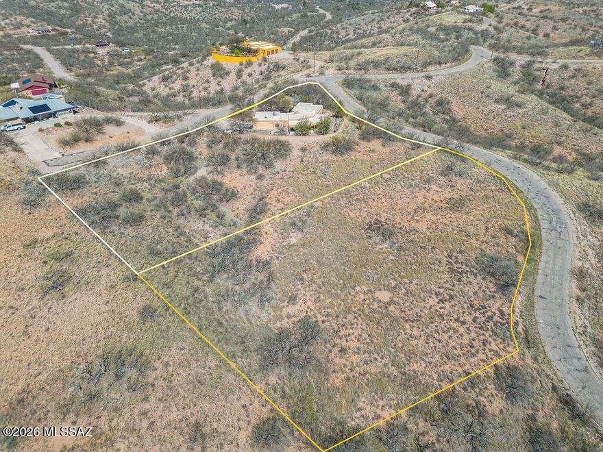 This property is being sold with MLS #22606792 (Parcel #115-15-407) for an opportunity to own a total of three parcels totaling 2.46 acres with a custom built 3-bed, 2-bath home offering spectacular panoramic views and exceptional privacy.

The property is uniquely positioned with Coronado National Forest bordering one side and additional privately owned land on the other, preserving the natural surroundings and preventing nearby development. The elevated hilltop setting provides peaceful desert and mountain vistas in nearly every direction. The home on the adjacent lot, included in this sale, offers classic Southwestern charm with a traditional beehive fireplace and several sliding glass doors that capture the views while bringing fresh mountain air into the living spaces. An Arizona room provides the perfect place to sit back and take in the surrounding landscape and views year-round. The layout takes advantage of natural light and the surrounding scenery throughout the home.

A spacious 3-car garage provides plenty of room for vehicles, storage, or hobby space. Located at the end of the cul-de-sac, the property enjoys a quiet setting with minimal traffic and a strong sense of seclusion.
