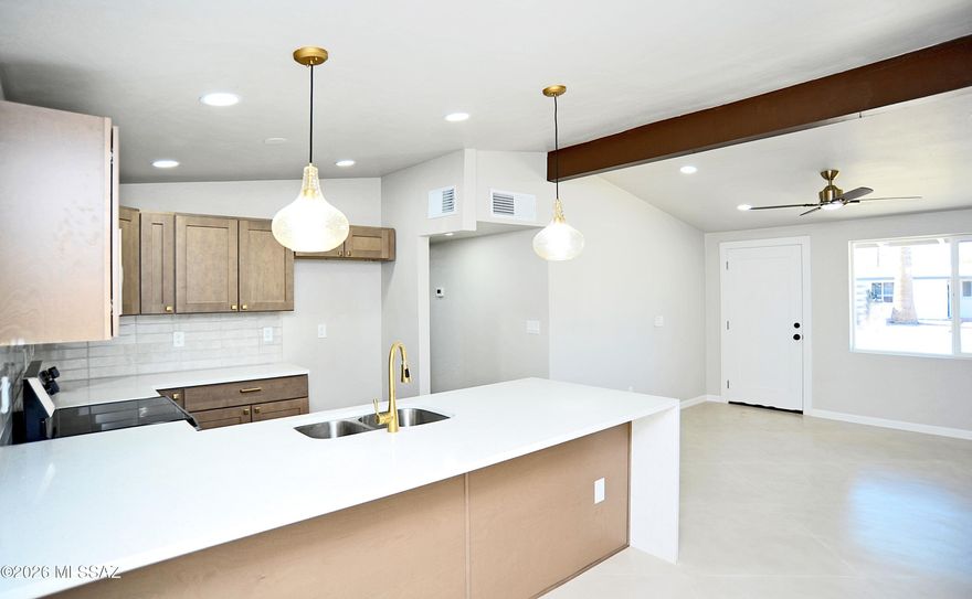 RANGE PRICED, SELLER WILL ENTERTAIN OFFERS FROM $275,000 TO $285,000! Beautifully remodeled home near Flowing Wells High School. Great location just minutes from I-10. New kitchen with quartz counter tops, custom concrete floors, and upgraded finishes throughout. Roof just coated, new windows, and new HVAC. This home is in near perfect move in condition. A huge bonus this home has a huge workshop and large lot. Don't let the square footage fool you, this one lays out large with a wonderful open floor plane. YOUR WILL LOVE THIS HOME! Owner/Agent