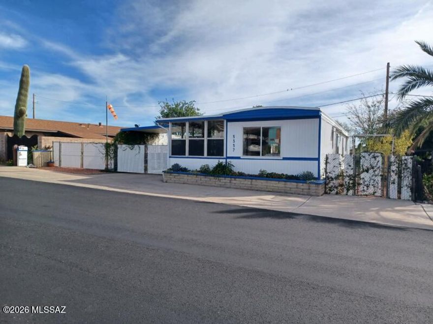 Beautifully updated home featuring fantastic mountain views. This move-in-ready residence offers peace of mind with a newer HVAC system, new Pex plumbing, on demand water heater and a recently recoated roof. The modern kitchen is a gorgeous center place, with a central island, 5-burner gas stove with a vented hood, and a dishwasher. Enjoy the outdoors from the comfort of two Arizona rooms, and take advantage of the functional laundry room and convenient storage sheds. Both bathrooms have been stylishly updated. Fenced Parking and Citrus Trees. As a special bonus, a golf cart included so you can immediately enjoy the HOA's unlimited golf. HOA incl 2 pools, 2 spas, Exercise Facility, Pickle Ball, Tennis, and More. Modern comforts with stunning scenery, rare find in a premier community.
