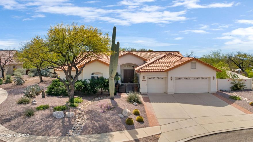 Enjoy Catalina Foothills living on a beautifully landscaped .48-acre cul-de-sac lot near Sabino Canyon Recreation Area. Gorgeous front landscaping and a welcoming front courtyard create an inviting entrance to this spacious 3,121 sq ft home with desirable north/south orientation. 
At the heart of the home is a bright white kitchen with a large center island, breakfast bar, and abundant cabinetry, opening to the family room with a cozy gas fireplace and patio access--perfect for everyday living and entertaining. The welcoming living room features vaulted ceilings and large picture windows that fill the space with natural light and frame the surrounding desert landscape. 
The thoughtfully designed split bedroom floorplan includes an enormous primary suite with direct patio access, creating a peaceful retreat.

Step outside to a beautifully landscaped backyard with fruit trees, offering space for outdoor living and room to add a pool. Additional features include a 3-car garage with extensive built-in storage and a central vacuum system.

Ideally located near Sabino Canyon Recreation Area, Udall Park, hiking trails, shopping, and dining, this home offers the perfect combination of space, comfort, and Catalina Foothills lifestyle.