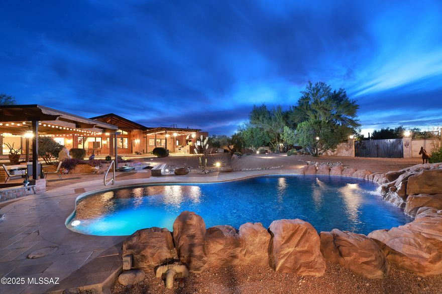 Incredible views of the Catalina & Rincon Mtns on 3.3 acres. Southwest style home showcases quality craftsmanship & decorative finishes. 2 Owners' Suite's each with private sitting room & full baths, plus 2 add'l bedrooms & baths. Kitchen has alder cabinets, custom hardware, double ovens, 2 stovetops & more. Spacious office with private entry.  Oversized 3-car garage with laundry & large storage room. Backyard, an entertainer's dream with a sparkling pool, poolside ramada, outdoor shower, covered patios, pizza oven and garden shed. Beyond the enclosed yard, discover an Artist Studio & Workshop/4th Garage. Near Saguaro National Monument East & Agua Caliente Park, golf, hiking & biking.Tanque Verde Schools. Low HOA.
