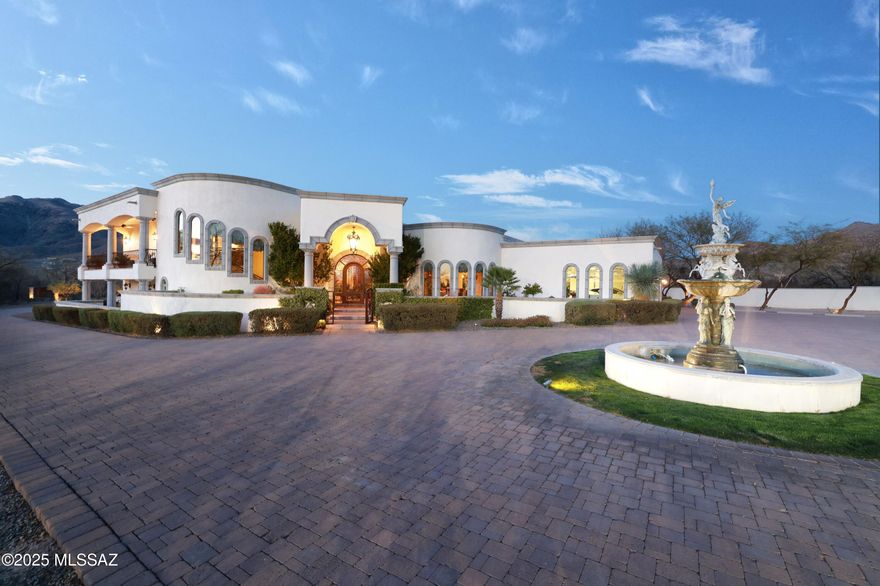 An estate of unparalleled luxury & sophistication-an ultra custom masterpiece nestled on 3.64 pristine acres at the very end of the road in the coveted Tanque Verde Valley. This one owner, iconic Mediterranean-Tuscan home, built by the renowned John Kline, is a statement of timeless elegance, refined comfort & unrivaled craftsmanship with no expense spared. 
As you approach, you are greeted by a stunning custom entrance & gate, framed by an exquisite paver driveway that winds through meticulously manicured grounds. As the long driveway ends your attention is drawn to the grandeur of a stately Italian fountain. The stage is then set for the magnificent residence offering breathtaking mountain vistas & exceptional equestrian facilities. SEE SUPPLEMENT. Open the impressive, massive custom wrought iron front door to an inviting foyer and formal living room and you will be be captivated by the gorgeous, lighted coffered ceiling.

At the heart of the home lies the gourmet chef's kitchen, outfitted with elite Wolf appliances, custom alder wood cabinetry, and gleaming granite countertops. Designed for both intimate gatherings and grand entertaining, the kitchen seamlessly connects to inviting living spaces, making it the center of most every gathering.

The owners bedroom suite is a private sanctuary of indulgence, boasting sweeping mountain, city, sunset and sunrise views from the east and west balconies. This sumptuous retreat features a refined sitting area, coffered ceiling, sensational stone fireplace, rich wood flooring, two expansive walk-in closets and its own washer and dryer. The lavish spa like bath suite epitomizes serenity, offering a deep-soaking jetted tub, a walk-through steam shower, dual water closets and vanities, and impeccable finishes that speak to the highest standards of luxury.

There are six exquisite bedrooms and five-and-a-half plush bathrooms which includes a private detached guest house complete with its own laundry, garage and storage. The recreation/media room in the main home offers excellent entertainment with optional pool table, shuffleboard, and a state-of-the-art fitness center featuring a dry sauna.

Step outdoors to a private oasis where resort living becomes a daily pleasure. A sparkling saltwater pool with a cascading slide, an inviting spa, and three stylish ramadas including an outdoor kitchen, replete with dual built-in BBQ grills, refrigerator, sink, fireplace and TV, are perfect for alfresco dining. Numerous private patios around the home provide intimate settings for friends and family to gather. There is also a children's play area with turf and a custom playset. For the sports afficionado, a lighted pickleball and basketball court offers endless hours of outdoor recreation.

Equestrian enthusiasts will delight in the impressive facilities, including a massive strategically ventilated covered barn, four large stalls featuring automatic waterers, a large lighted arena, a tack room, hay storage, a wash rack, bathroom, and a fire pit. Unlimited horseback riding opportunities await with riding out off the property directly to miles of incredibly scenic trails and the Agua Caliente and Tanque Verde washes for all levels of riding.

This sensational estate also provides modern conveniences with a Control4 Smart Home system, energy-saving solar panels, 2 separate custom wrought iron electric gates, and a spacious three-car garage with a newly coated floor, an electric car charging station, built-in storage, and television.

The serene, cul-de-sac location offers unmatched privacy and tranquility ideally located just minutes from shopping, premier golf courses, fine dining, and top medical facilities. This estate exemplifies extraordinary living while maintaining accessibility to life's necessities.

It is not just a home - it is a legacy of comfort, luxury and elegance. Discover this rare ownership opportunity, where every detail is designed to inspire and delight the senses. This one-of-a-kind property is a true retreat you will never want to leave.
