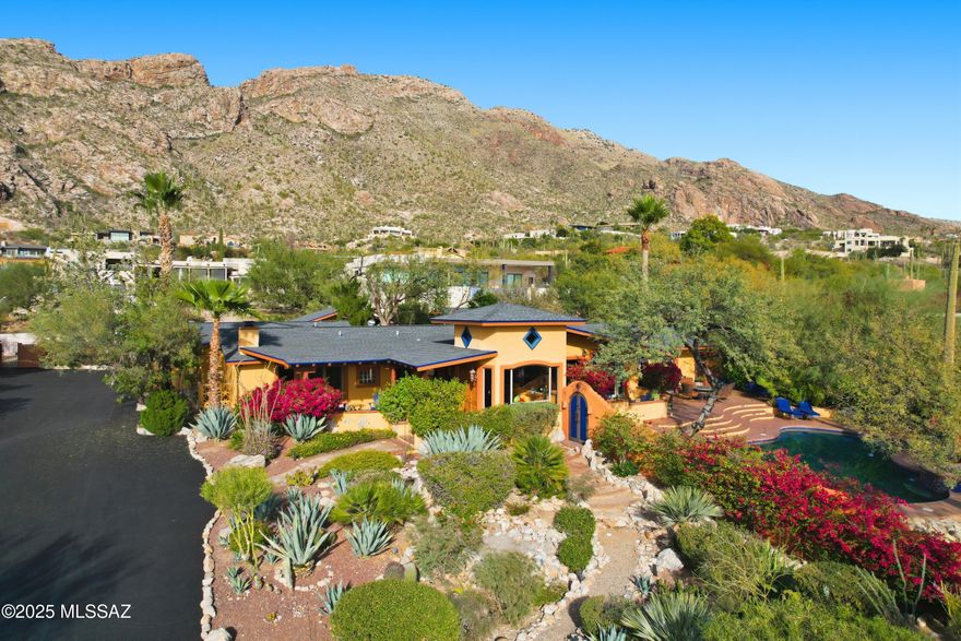 Experience quintessential Southwest living in this exceptional Tucson estate, offering a stunning blend of comfort & character. 4-bedroom, 5-bath + office main house features a split floor plan, authentic Saltillo tile, & colorful finishes. Striking 2-sided fireplace warms both family & living areas. Primary suite is secluded w/a cozy kiva fireplace & private patio. The stylish yet functional kitchen opens to dining areas which flow easily to the outdoor covered patios. Resort-style yards create a desert oasis showcasing mature vegetation, featuring a luxurious pool & spa w/an endless view backdrop, separate casita, studio w/sauna & relaxing waterfalls. Roofs replaced in 11/25. Convenient yet private location at the top of Swan w/ A+ views!  Near shopping, dining, schools, hiking, and more