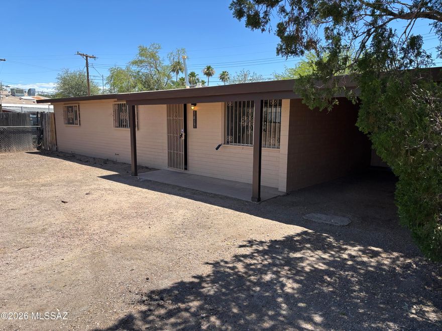 Now available is a 3 bedroom 1.5 bath house. Seller is offering a 3% concession to the buyer with an accepted offer!! This property features a new exterior paint, a single car carport, tile flooring throughout, brand new granite countertops and a new AC installed in 2025 and a new roof in 2026. Roof comes with a 2 year warranty. The huge covered back porch also has an attached, extra large storage room. House also has washer and dryer hookups and a fenced backyard. A new stove and refrigerator will be ordered and installed before close of escrow. This home is across the street from Douglas Elementary School, has easy access to I-10 and is near the Tucson Mall, libraries and restaurants.