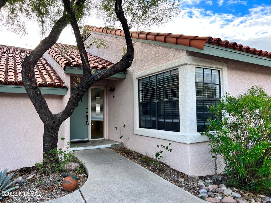 Located in the Catalina Foothills, minutes to La Encantada Mall, this 2bdr/2ba single floor condo is all on one level but feels like it is on the second floor due to the hillside location! Private patio offers mountain and city views. Spacious ceiling room w/vaulted ceilings and fireplace, kitchen offers lots of cabinets and counter space w/an additional bar sink. Dining area overlooks patio and there is another space that could be used for sitting area or dining. Primary bedroom has walk-in closet w/ensuite that features dual vanity and shower. Hall bath has tub/shower.