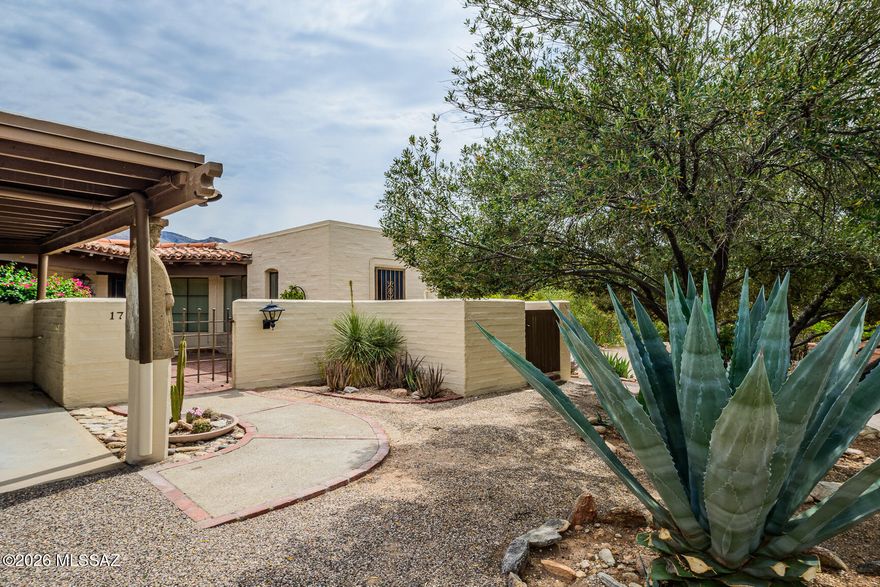 This architecturally significant townhome community, designed by renowned architect Juan Worner Baz, in conjunction w/Japanese landscape architect Taro Akutagawa, is listed in the Natl Register of Historic Places. Enjoy expanded patio w/panoramic Catalina Mountain views to Finger Rock. Mature desert landscaping incl/saguaros, cypress, eucalyptus trees, agave & aloe plants, & an impeccable flowering desert garden. Enjoy walking paths adorned w/statues, unique community pool, waterfalls, & Koi Pond. Addtl highlights of this special 2BR, 2BA home incl/a private carport w/one addtl covered space, multiple storage closets, & addtl adjacent guest parking. HOA dues cover ALOT (water, sewer, trash, fire subscription, exterior painting, roof maintenance, landscaping, & common area upkeep.