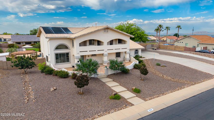Perched on 0.8 acre in Canyon de Flores, this stunning 5BR/3BA two-story solar home offers luxury, space, and unforgettable mountain views! Enjoy breathtaking sunrises and sunsets from the flagstone courtyard or multiple private balconies. Inside, soaring ceilings, abundant light, two spacious living areas, and a gourmet kitchen w/granite countertops & luxurious wood cabinetry, double ovens, stainless appliances, breakfast bar, & walk-in pantry blend elegance and comfort. The spacious primary suite features a huge private balcony and spa-like bath. Backyard oasis includes pool, spa, separate pergola space, huge turf play space, raised garden, playground, storage shed, w/ dual driveway access to the backyard and space to park the RV. Close to shopping, schools, and Ft Huachuca.