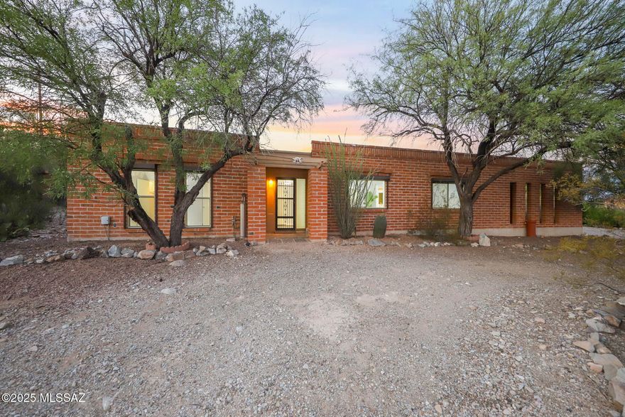 Nestled on a 1.11-acre hilltop surrounded by Tucson's natural desert landscape, this stunning 3-bedroom, 2-bathroom home offers spacious living with an open floor plan. Relax by the fireplace and take in the scenic residential hilltop views while enjoying amazing Tucson sunsets.