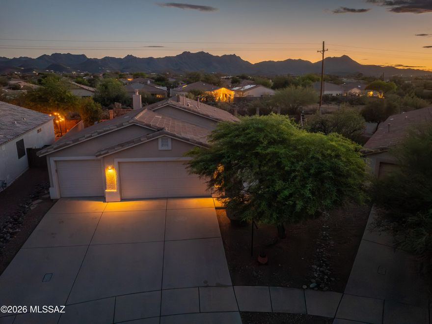Come see this beautiful, move-in-ready home! Inside, enjoy fresh paint, upgraded flooring, vaulted ceilings, a new tile fireplace, and a split floor plan with an updated, modern primary suite. The spacious three-car garage also includes a dedicated workspace or storage room.

Outside, the oversized lot backs onto a natural buffer zone, perfectly blending desert serenity with gated community security. This certified National Wildlife Federation neighborhood features scenic trails, and the year-round heated community pool and playground are just a 5-minute walk away. Plus, you are ideally located just minutes from local shopping and I-10 for an easy commute.