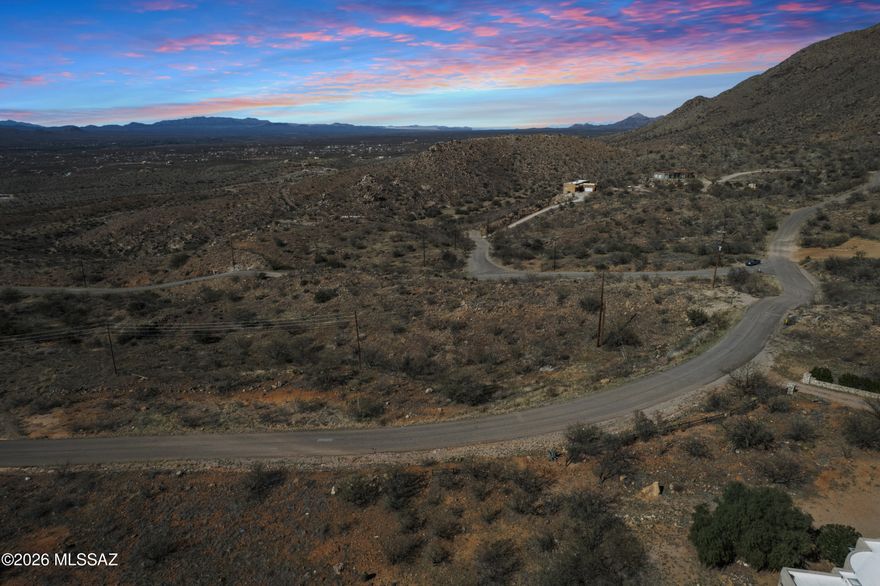 Drive out along Via San Cayetano and step onto your own 1.02-acre lot in Rio Rico Ranchettes, where established homes nearby show exactly what's possible. The sloped terrain features a naturally flatter build area, water and electricity are available nearby.

Zoned R-2 Residential in Santa Cruz County with flexible owner financing available, this growing area outside city limits is as accessible as it is full of potential. A secondary access point from Avenida Calamar adds even more flexibility for your build plans. Don't miss your chance to secure land in one of Arizona's most promising communities!