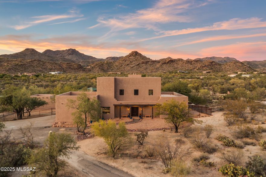 Are you searching for a quiet, peaceful life?  This home presents an AMAZING opportunity to experience lush desert, mountain views, and star gazing.  The beautifully updated home on 13.4 acres gives you the buffer of peace and quiet!  Set at the base of the Tortolita Mountains, this property has magnificent 360 views.  The updated, open concept home has a gorgeous kitchen with wide open views of the mountains from the living and dining area.  Two fireplaces, one in the living area and one in the primary bedroom add to the homey, comfy feeling of this home.  The flooring is tile throughout, and includes an office space and a large bonus room for hobbies, exercise or entertainment.  Enjoy sunset views from the balcony in the enormous primary suite with plenty of space for a home gym and an office.  This home was built with steel frames, has extra insulation and new exterior paint. The four car garage/workshop gives you room for all your hobbies.  The horse facilities include a mare motel, large turnout areas and additional pens.  It has No HOA and is in a wonderful, horse friendly neighborhood with a secluded feel, but keeps you conveniently close to northwest Tucson and Oro Valley stores and restaurants.  Come see it today!