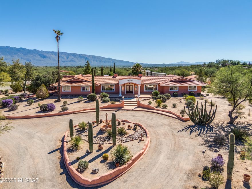 Exquisite, privately walled and gated estate in Northeast Tucson. Nestled on nearly 6 acres in the heart of the stunning Tanque Verde Valley, this luxurious hacienda-style estate offers panoramic views of the Santa Catalina and Rincon Mountains. With over 5,000 sq. ft. of living space, the property includes a main house, guest house, oversized 3-car attached garage with brand-new doors and openers under warranty, oversized 5-car detached garage, RV carport, workshop, greenhouse, and a separate storage building. The open floor plan, filled with natural light from abundant windows, creates a bright and airy ambiance. The freshly painted and professionally cleaned interior welcomes you with warmth and comfort. Two wood-burning fireplaces add to the relaxing atmosphere. The expansive gourmet kitchen features custom, high-quality cabinetry, a large island, and updated top-of-the-line appliances. A separate butler's kitchen offers additional cabinetry, counter space, and laundry hookups. The gorgeous primary suite includes a massive walk-in closet and a spacious bathroom with dual vanities, a soaking tub, walk-in shower, exercise room, and sauna, not to mention pool, garden and mountain views! Three generous guest bedrooms in the main house each have private full bathrooms, with two offering separate exterior entrances. This unique home boasts multiple dining areas, a formal dining room, living room, family room, flex room (ideal as a library, study, office, or game room), and two powder rooms. The exterior is equally impressive. A grand covered front entrance showcases breathtaking views of the Santa Catalina Mountains, leading to a wraparound porch with equally stunning vistas. The expansive covered patio at the rear of the home, accessible from several rooms, opens to a private desert oasis. The fully fenced backyard features a sparkling, professionally maintained pool with a brand-new pump, newer artificial turf, mature vegetation, low-maintenance landscaping, and multiple outdoor seating areas - including an additional covered patio off the kitchen, gazebo, pergola, and BBQ area - perfect for entertaining or relaxing under the Sonoran sun and stars. The 560 sq. ft. guest house, with 1 bedroom and 1 bathroom, is tucked away at the end of a long driveway, ensuring complete privacy for owners and their guests. Recent upgrades include full replacement of the main house tile roof underlayment (a couple of years ago), flat roof recoating (October 2025, with a 2-year warranty), new garage doors and openers (October 2025, under warranty), full painting of the interior (October 2025), stucco repairs (October 2025), comprehensive termite treatment (July 2025, with active 2-year warranty), new pool pump (October 2025, on warranty) and extensive landscaping (October 2025). Zoned as a horse property and spanning 5.73 acres, this estate is a dream come true for equestrian enthusiasts. With endless possibilities, this magnificent property is truly a rare find. Bring your creativity and make it your own - experience life in your private piece of paradise. / Visit the "Documents" section of the listing for pictures of the butler's kitchen, guest bedrooms and bathrooms, guest house, garage and RV carport. / Natural gas is available in the street. / The listing agent is related to the trustee.