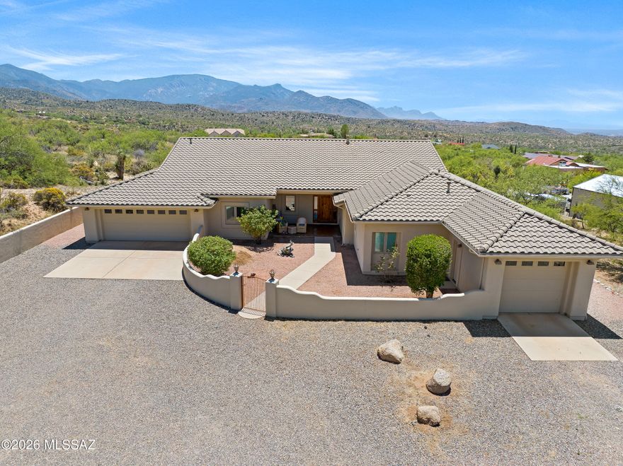 Tucked into one of Oracle's most desirable custom home neighborhoods, on a peaceful no-through road, this first-time-on-market retreat blends rural luxury with serene desert living. Set on 1.5 private acres with breathtaking mountain views & NO HOA, this lovingly maintained home offers the perfect balance of comfort, space, & serenity. Inside, soaring ceilings create an airy, inviting feel, while a stunning dual-sided fireplace creates warmth & ambiance between the dining & family rooms-the perfect centerpiece for cozy evenings or entertaining guests. Thoughtful updates, including a new HVAC system, water heater, dishwasher, & refrigerator, make everyday living easy. The spacious layout is designed for both quiet mornings & lively gatherings, with natural light pouring in from every angle. Outside, enjoy the beauty of the high desert with mature landscaping, French drains for added functionality, and room to truly breathe. Two attached garages provide abundant space for 3 vehicles, hobbies, or outdoor toys. Whether you're sipping coffee while watching the sunrise over the mountains or hosting friends under Arizona's star-filled skies, this property captures the magic of Oracle living with privacy, charm, & just the right touch of upscale country elegance.